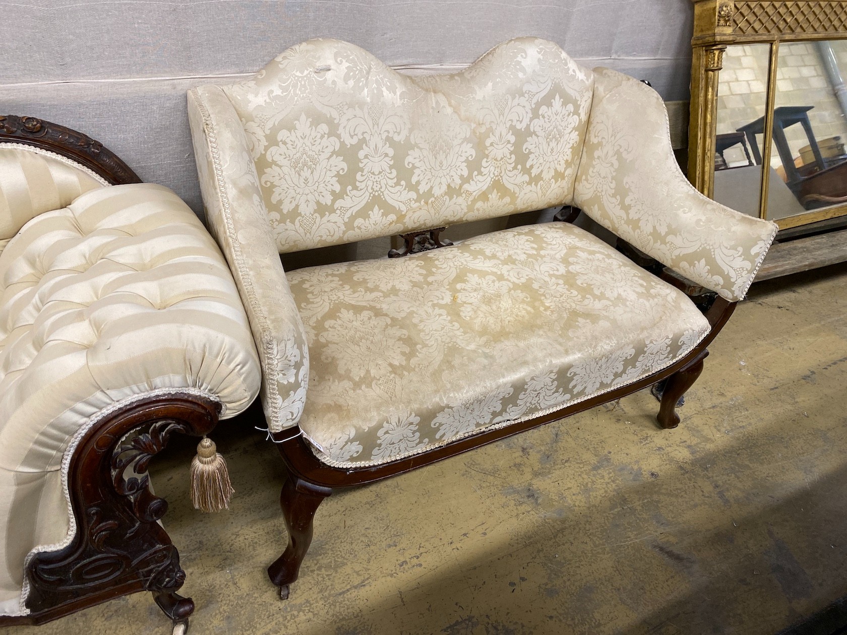 A late Victorian upholstered mahogany framed settee in cream damask, length 124cm, depth 68cm, height 82cm